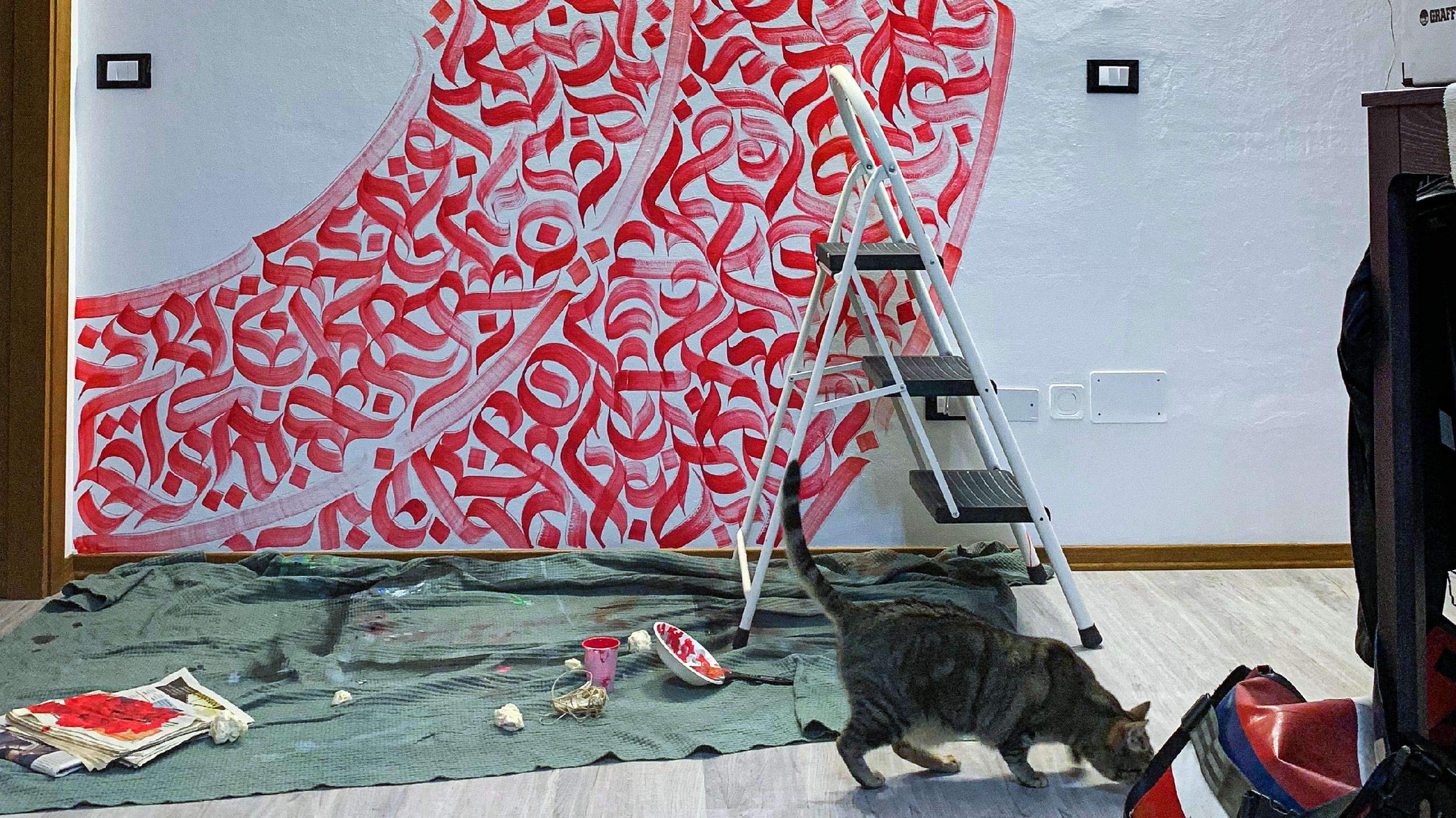 Shot of the work in progress of the mural. With special guest.