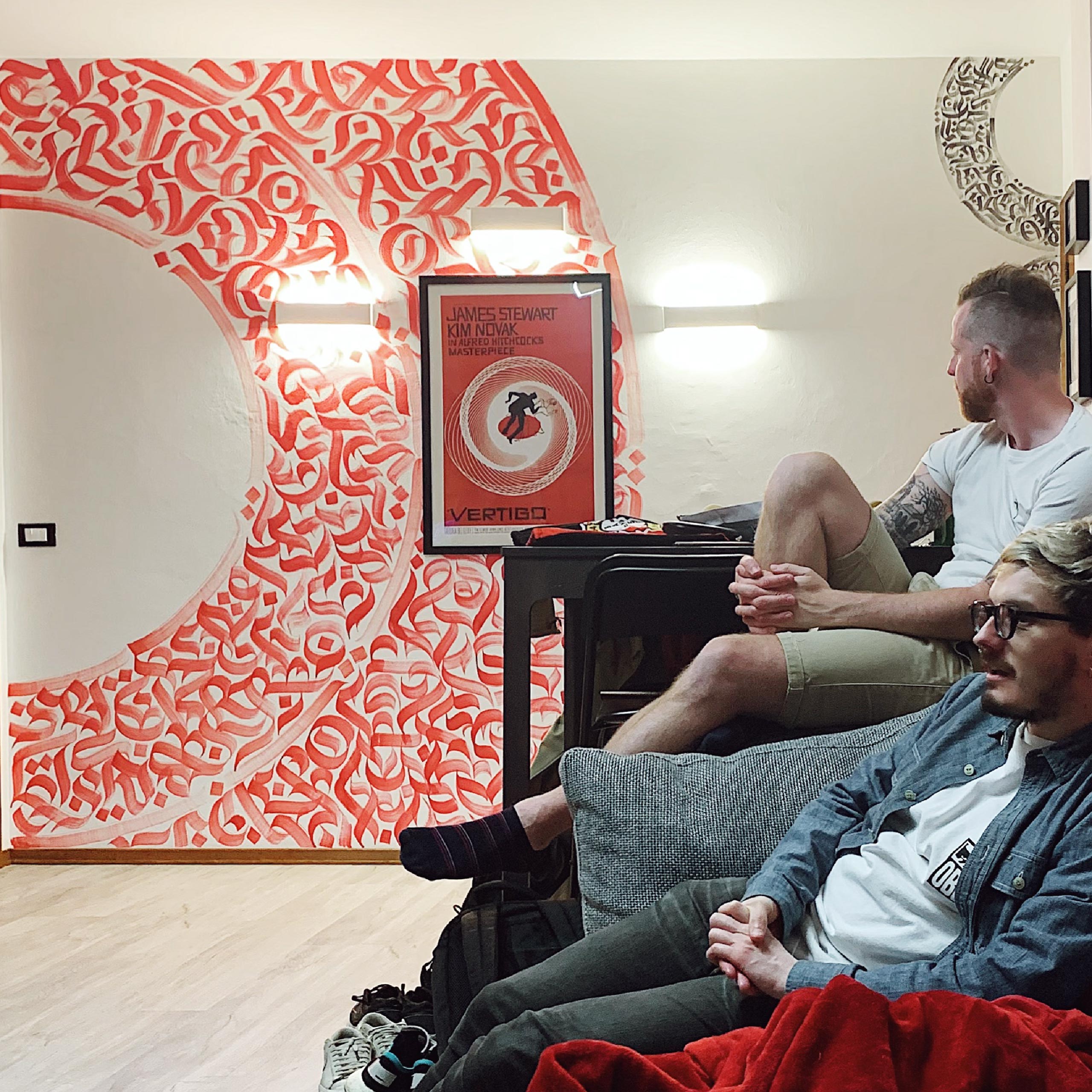 A shot of the living room, from the wall opposite the mural, with guests chilling it out. 